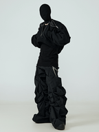 This anti-fashion uneven hem black coat features irregular raw hemline and minimalist dark silhouette, expressing rebellious deconstructed alternative aesthetics.