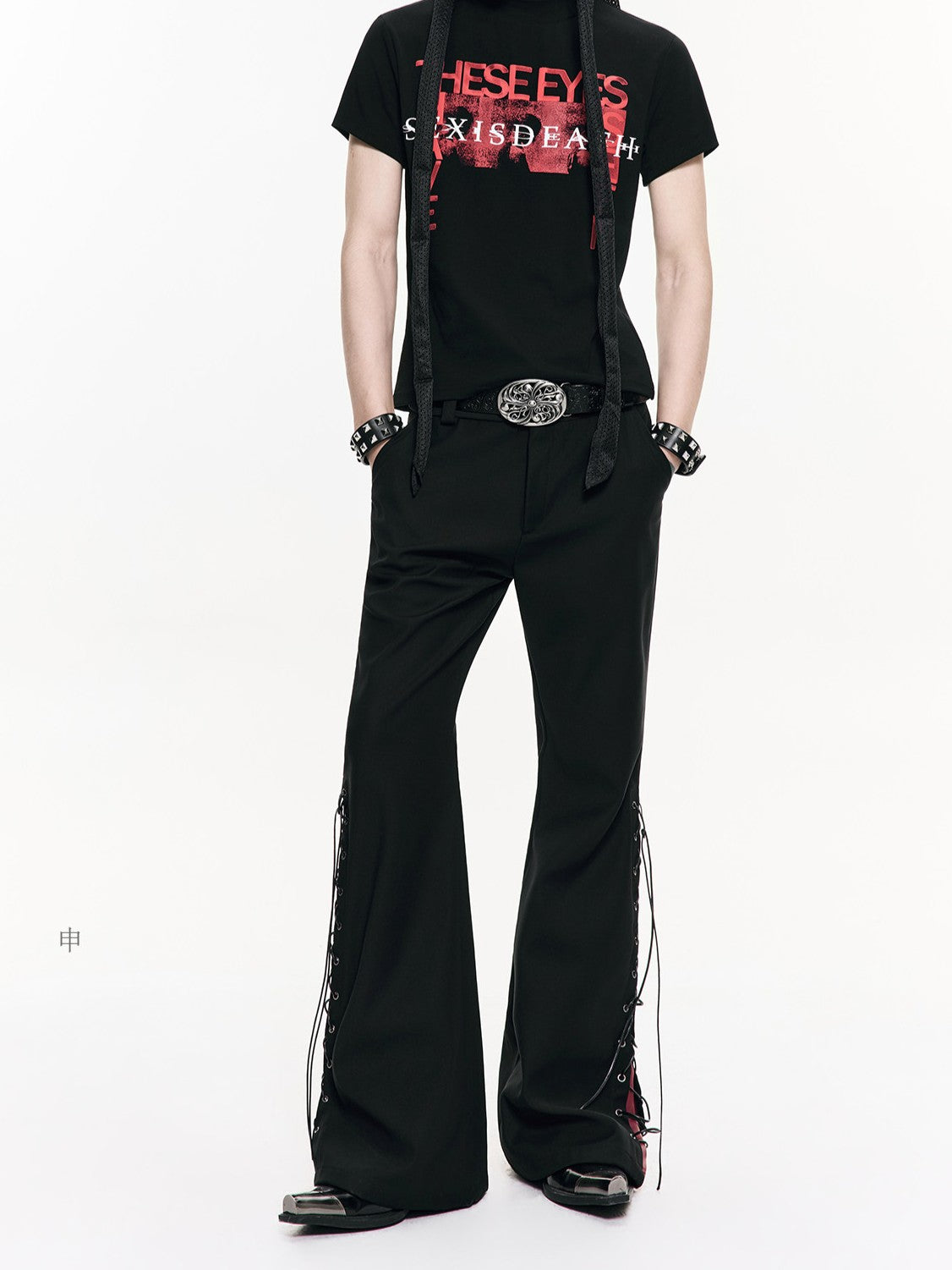 Cursed print worn black cargo pants with faded, broken-in fabric and haunting dark graphics, blending utilitarian cargo structure with eerie underground alternative style.