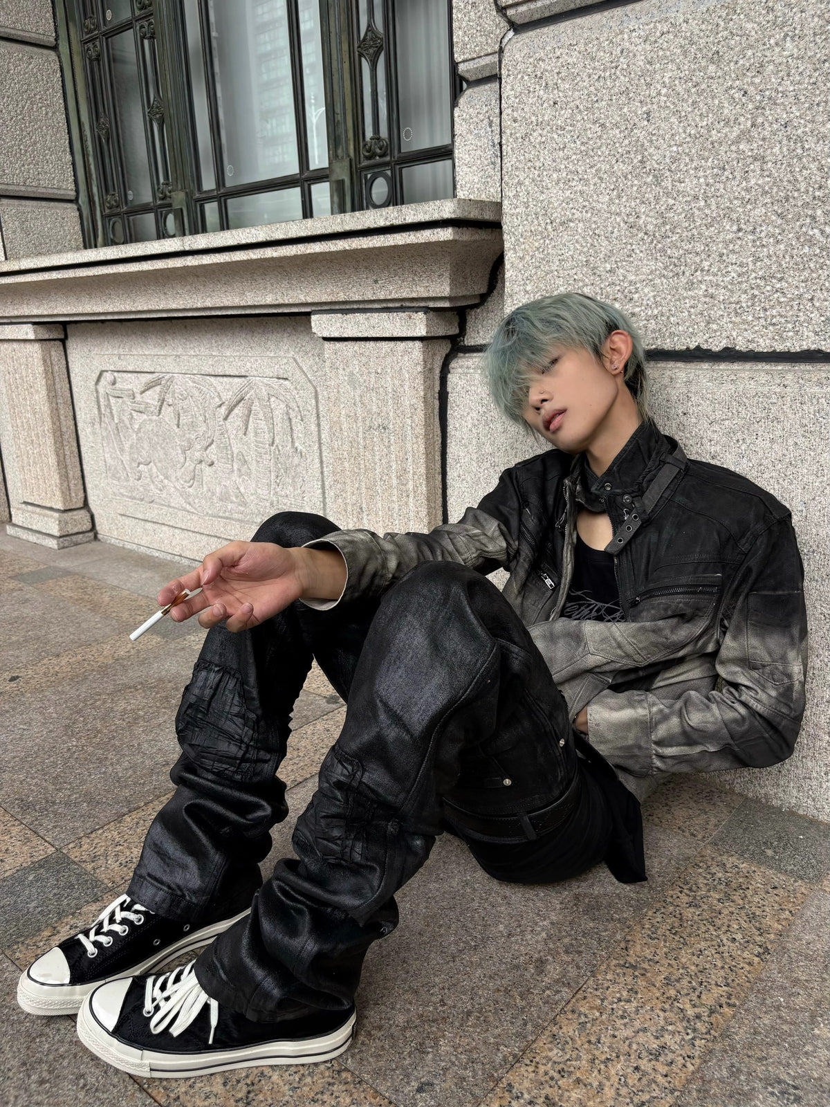 This dark urban layered faded cotton jacket features stacked construction and worn washed texture, delivering moody alternative streetwear vibes.