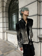 This grunge distressed black asymmetric top features frayed detailing and an irregular cut for raw, edgy alternative styling.