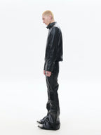 Black denim pants accented with bold industrial hardware, blending rugged utilitarian detail into dark alternative street styling.