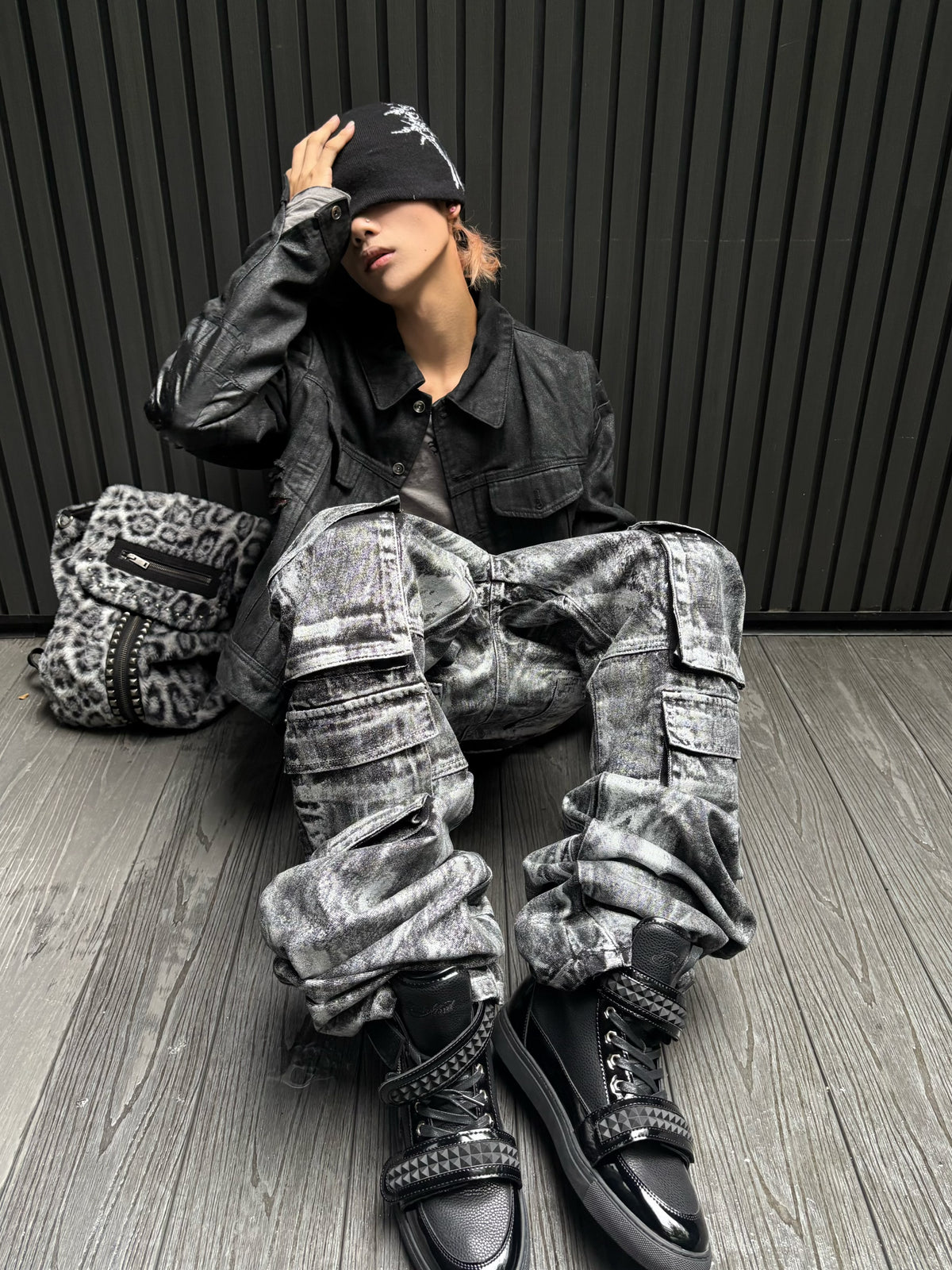 This rebel-style layered black graphic hoodie blends edgy prints and stacked detailing for a striking street look.