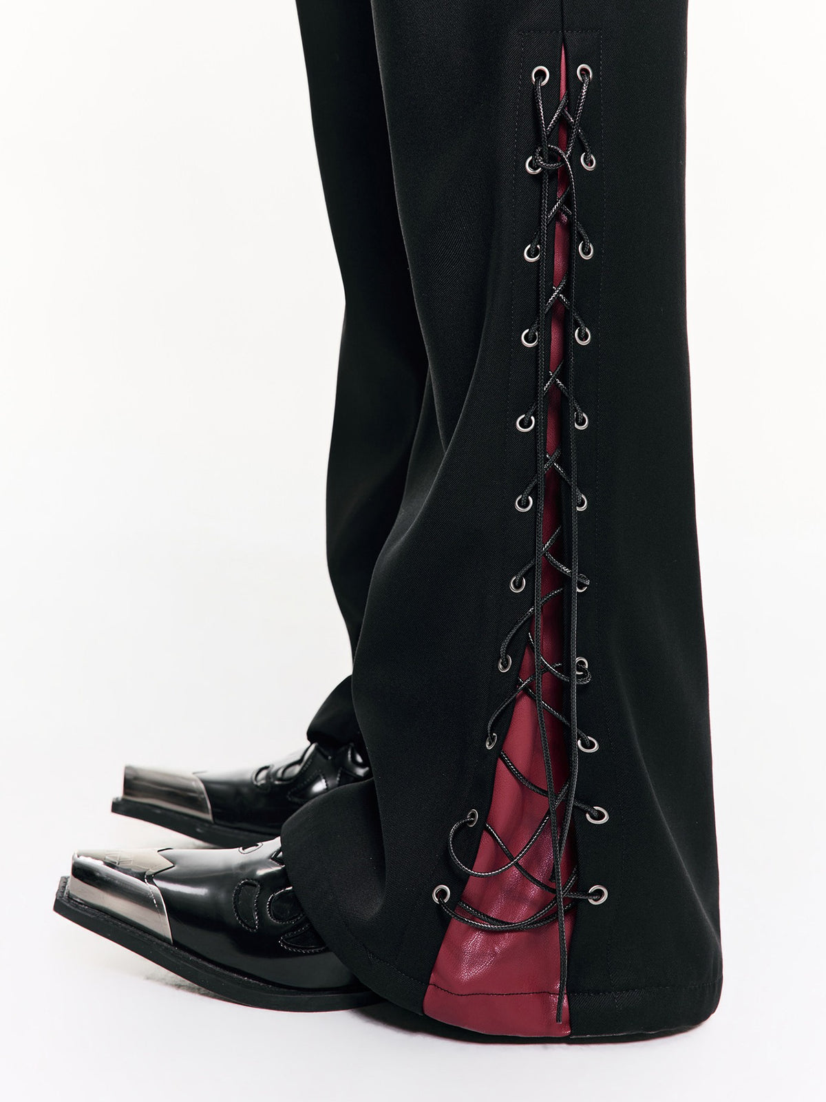 Ripped monochrome underground coat with frayed tear details and solid dark tones, carrying raw subculture grit for bold alternative layered looks.