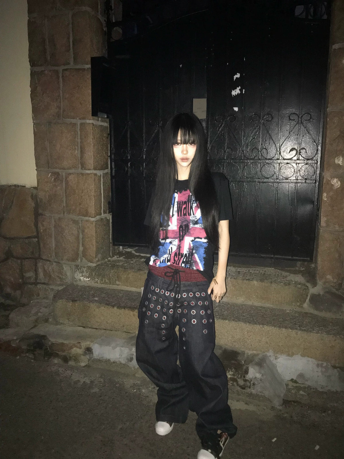 Unique upcycled-patch details bring character to this reworked grunge garment. Hand-sewn mixed fabric patches and raw unfinished edges craft one-of-a-kind textured style for alternative streetwear aesthetics.